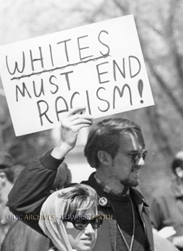 Apr. 6, 1968,
A U of I sociology instructor holds a sign speaking out against racism.